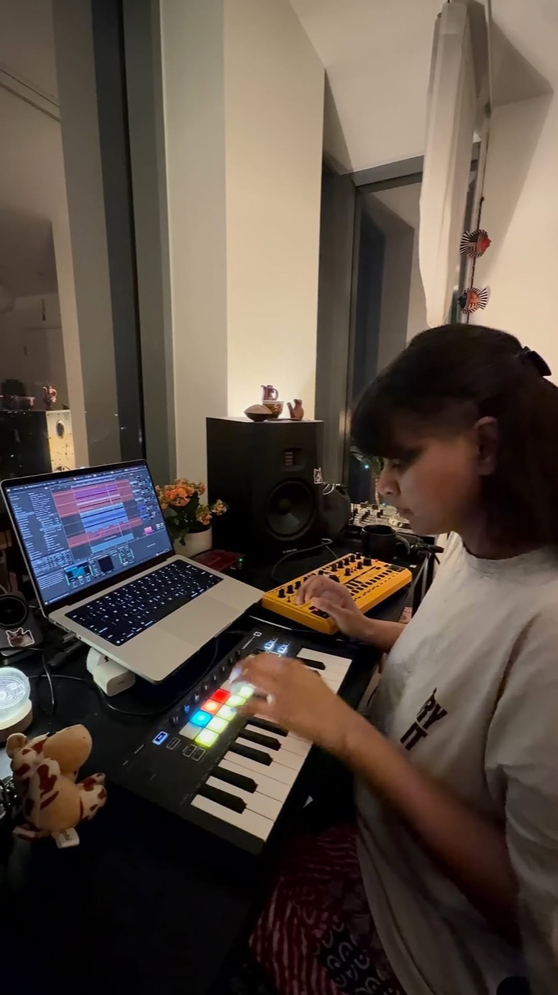Prerna Singh producing at home with a laptop, keyboard and drum machine
